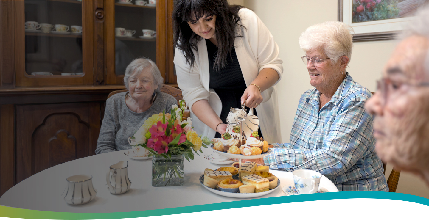 Team member pouring tea for residents during afternoon tea at Atrium Retirement Residence in Orillia, reflecting warmth, connection, and daily life.